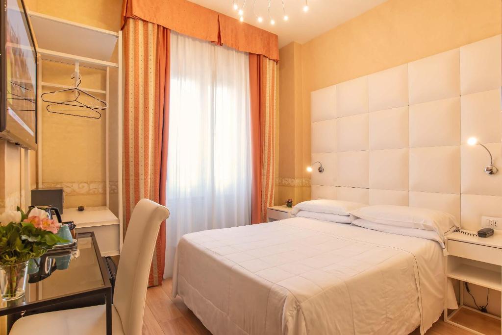 Postel nebo postele na pokoji v ubytování Hotel Jane