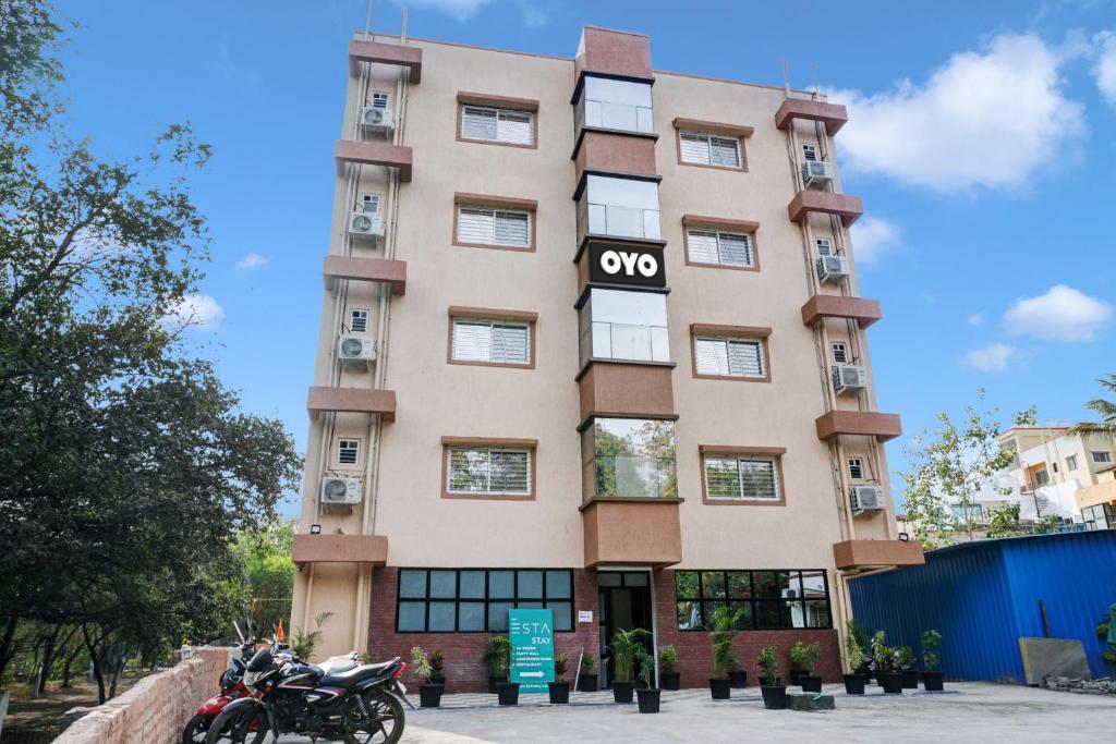 a building with a motorcycle parked in front of it at OYO Esta Inn in Pune