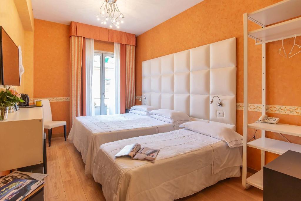 Postel nebo postele na pokoji v ubytování Hotel Jane