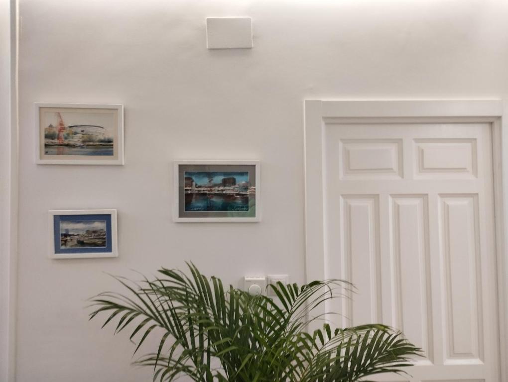 a white door in a room with pictures on the wall at Apartamento La Carola in Bilbao