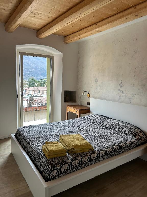 a bedroom with a large bed with a window at Casa Renzo in Arco