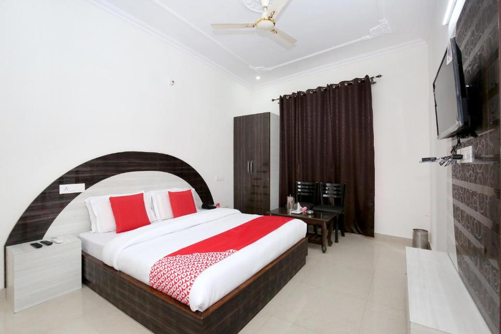 a bedroom with a bed and a television in it at Hotel Kamal Palace in Chandīgarh
