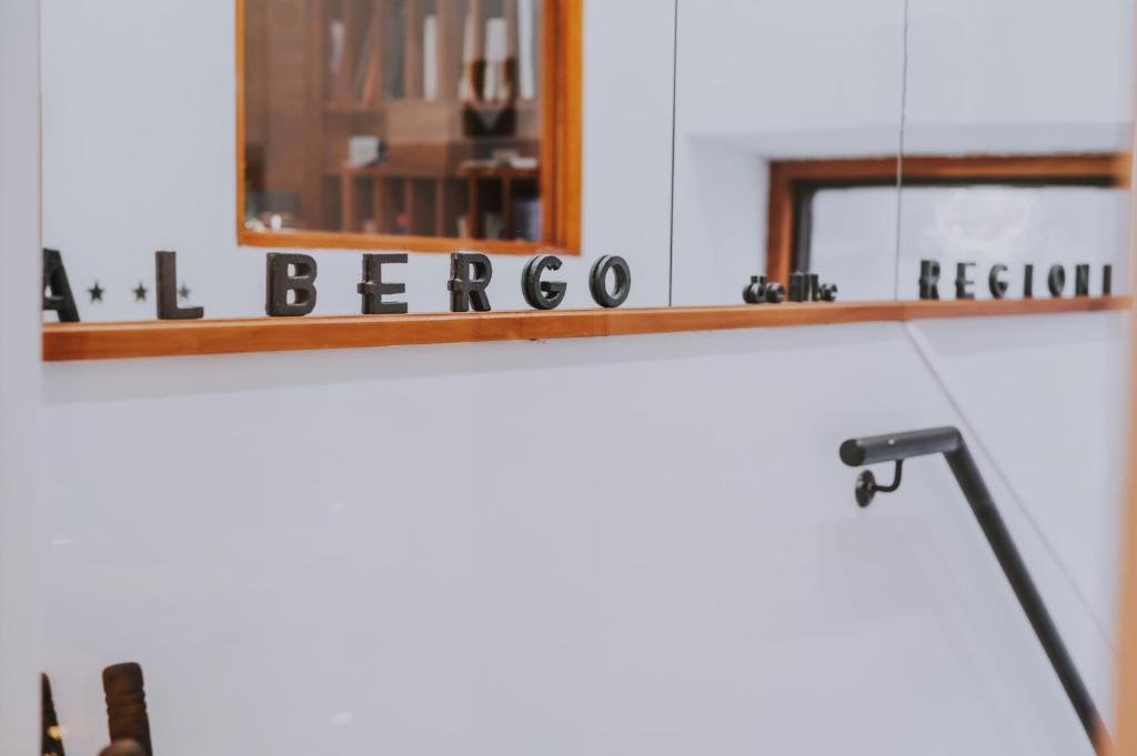 a desk with a lamp and a mirror at Albergo Delle Regioni, Barberini - Fontana di Trevi in Rome