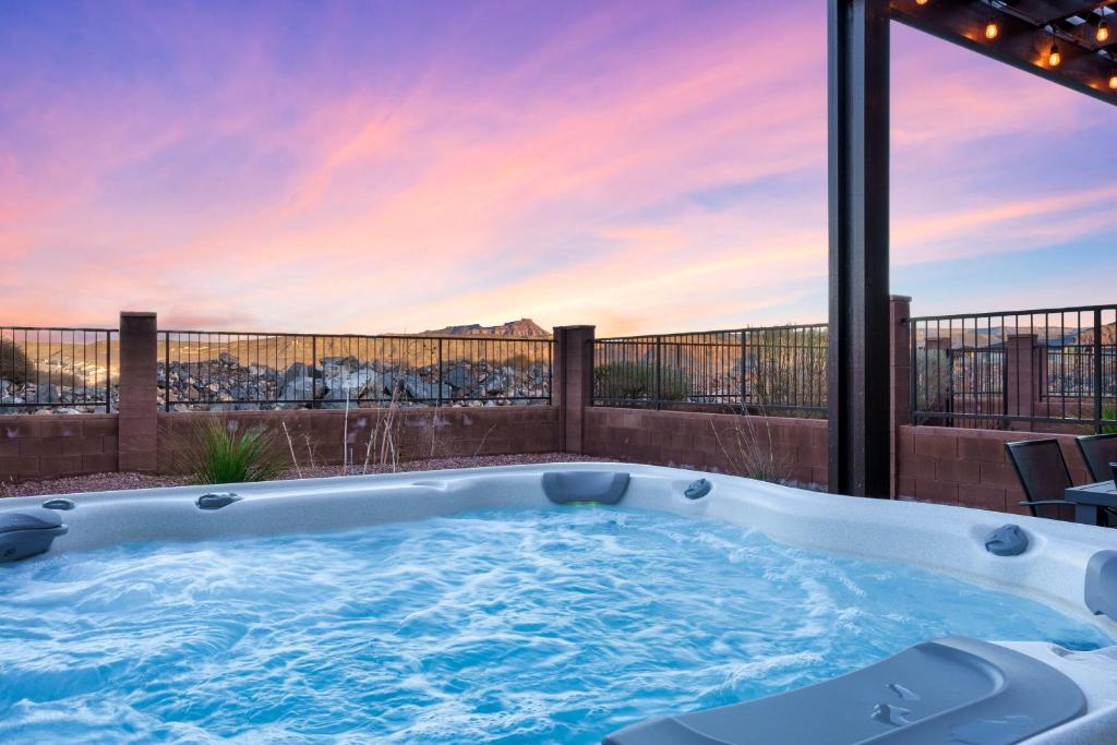 a jacuzzi tub on a balcony with a view at Savannah's Zion Retreat-NEW PRIVATE HOT TUB in Hurricane