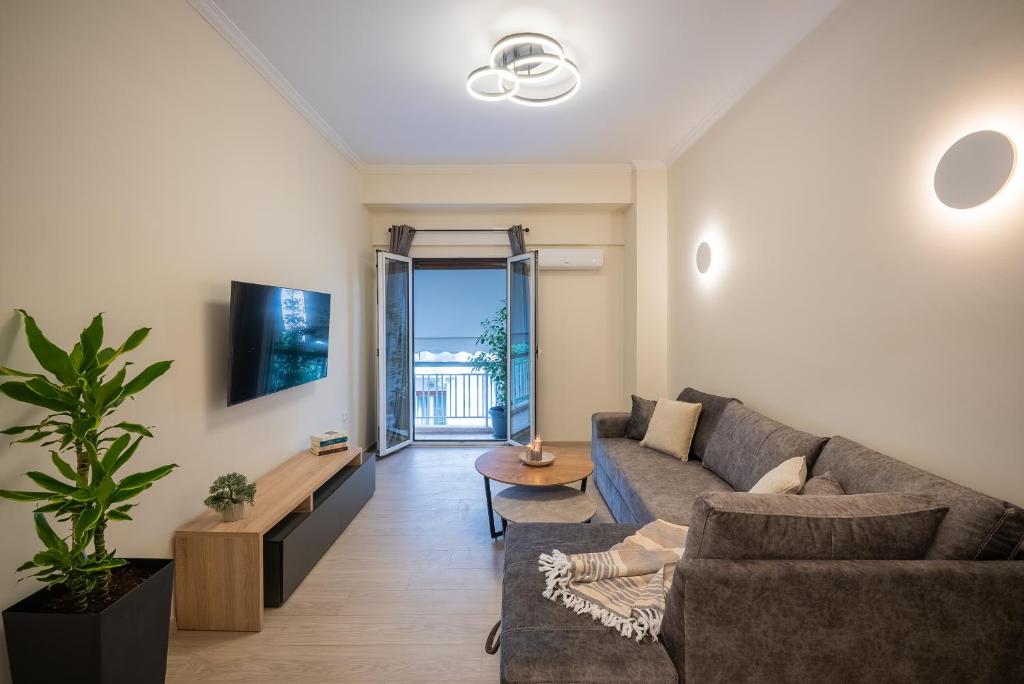 a living room with a couch and a tv at Central 2 Bdrm Aprt In Koukaki! in Athens