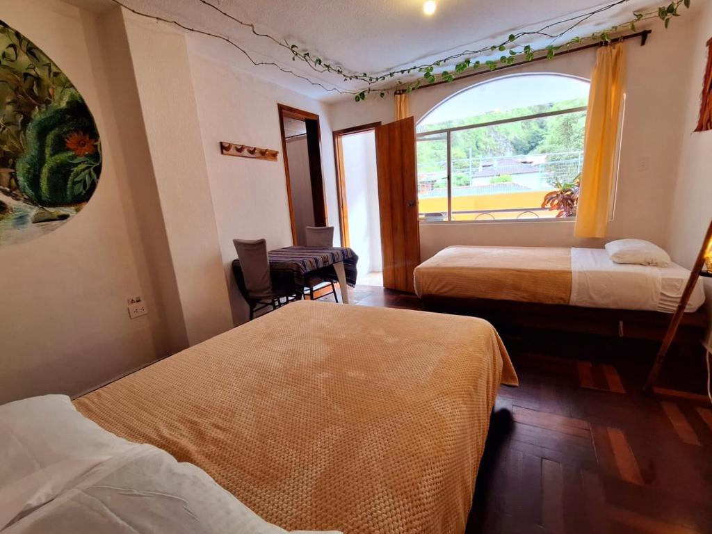 Postel nebo postele na pokoji v ubytování Hostal Chimenea