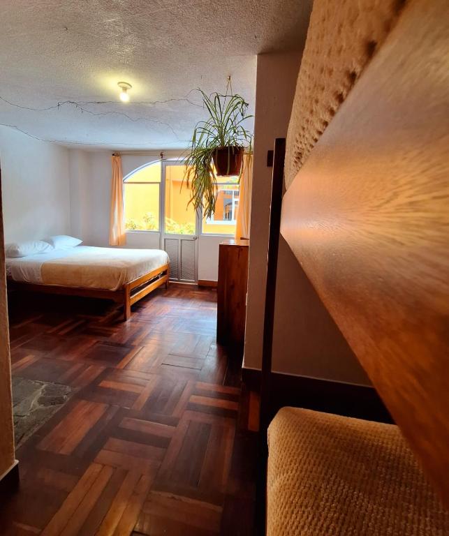 Postel nebo postele na pokoji v ubytování Hostal Chimenea