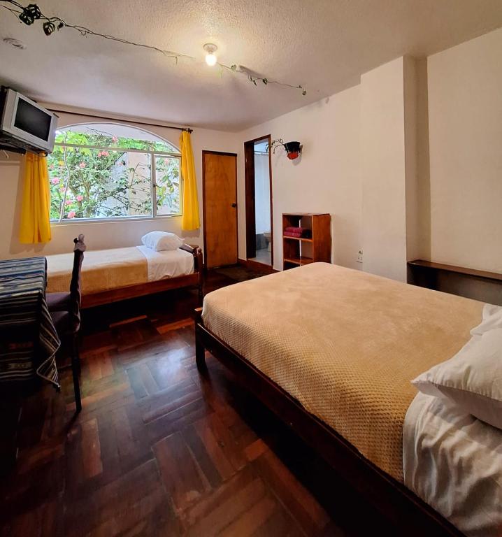 Postel nebo postele na pokoji v ubytování Hostal Chimenea