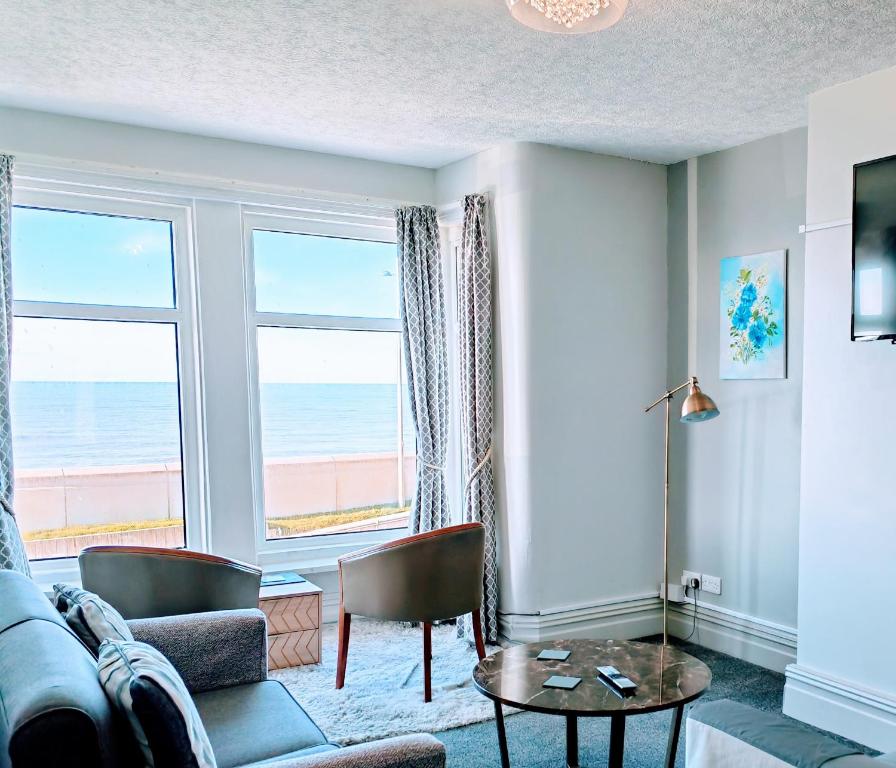 a living room with a view of the ocean at Seahawk Holiday Apartments in Cleveleys