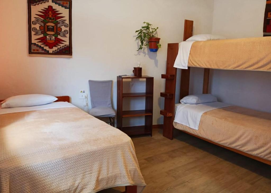 Postel nebo postele na pokoji v ubytování Hostal Chimenea