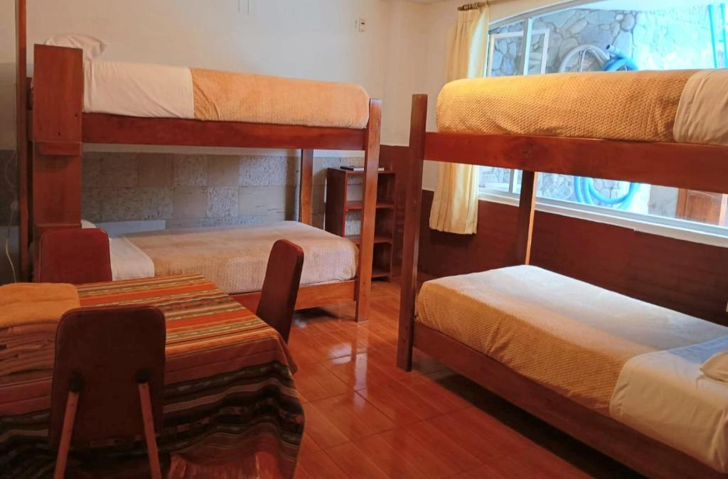 Postel nebo postele na pokoji v ubytování Hostal Chimenea
