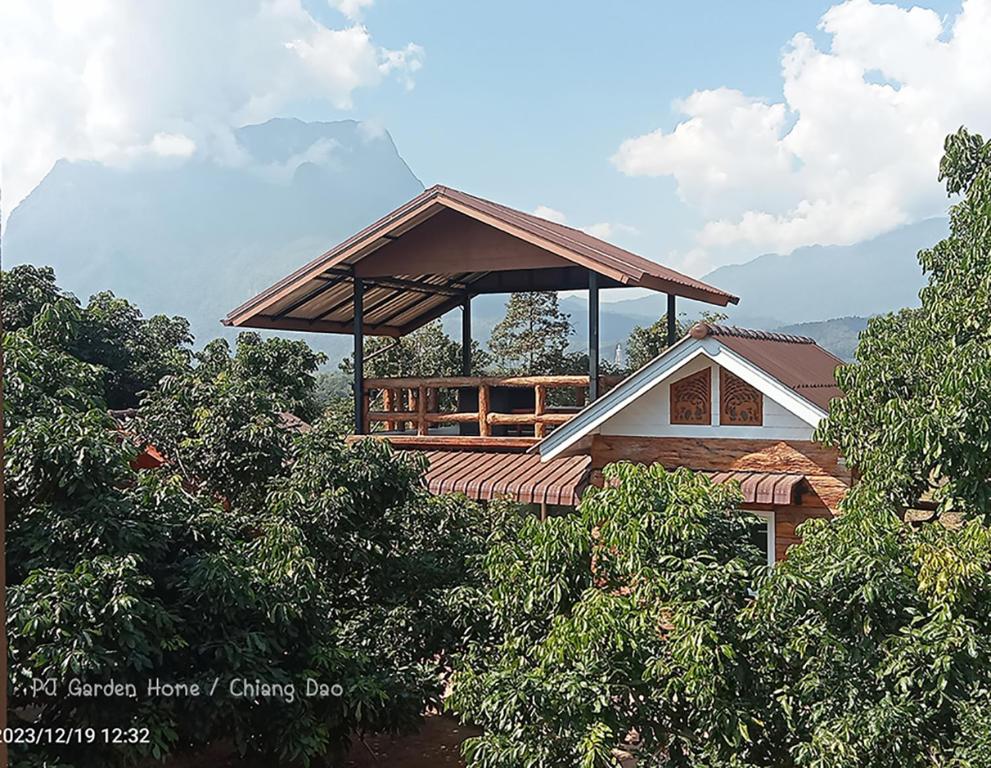 a building with a roof on top of trees at PJ Garden Home (Chiang Dao) in Chiang Dao
