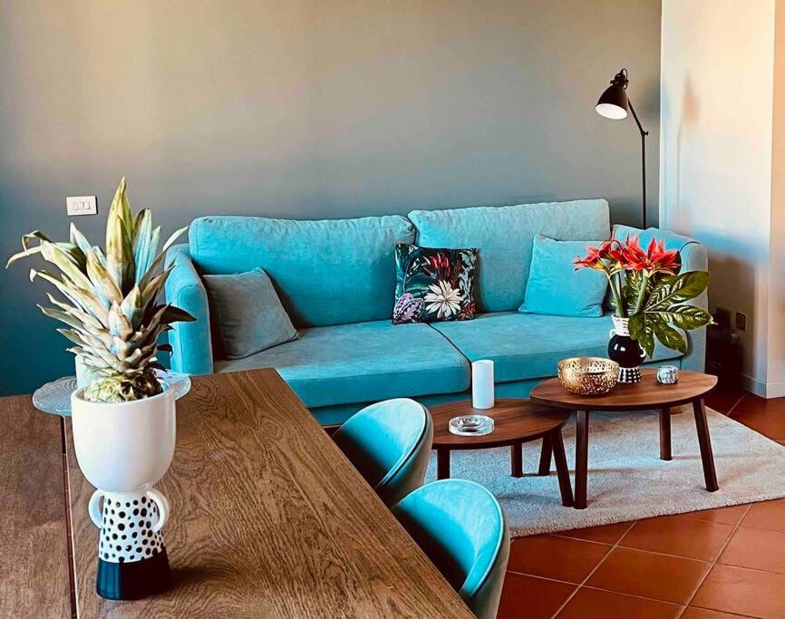 a living room with a blue couch and a table at La casa di Nina in Montespertoli