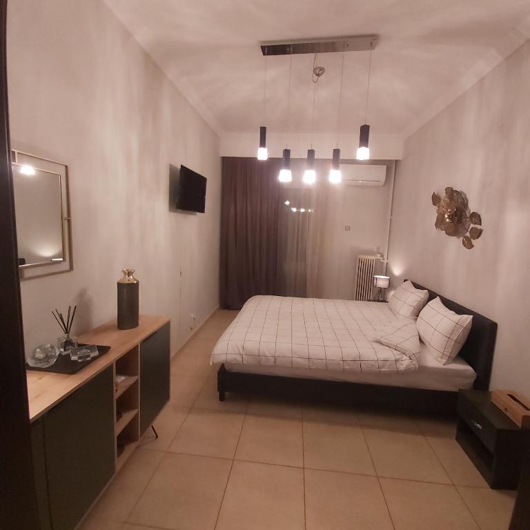 sypialnia z łóżkiem i umywalką w obiekcie Vaggoula's Luxury Apartment 1 w mieście Seres