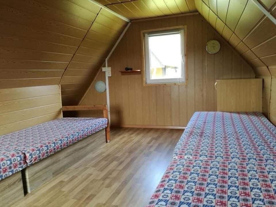 a bedroom with two beds in a attic at Chata Dominika in Dolná Strehová
