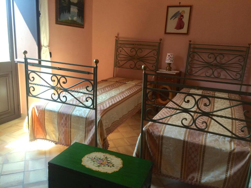 Postel nebo postele na pokoji v ubytování Palazzo Cutrufelli