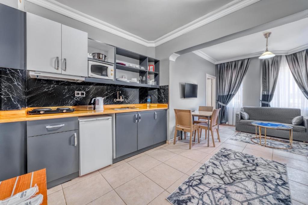 een open keuken en een woonkamer met een bank bij Kleopatra ICARIA Apart Hotel in Alanya