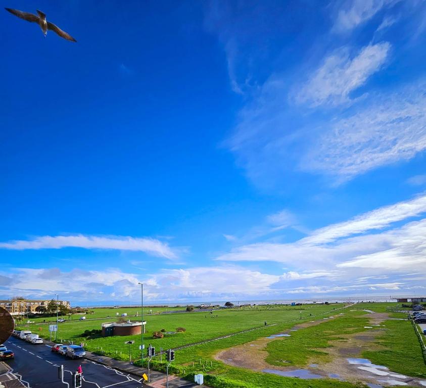 an airplane flying over a field and a road at Seaview 2 bedroom apartment in Littlehampton