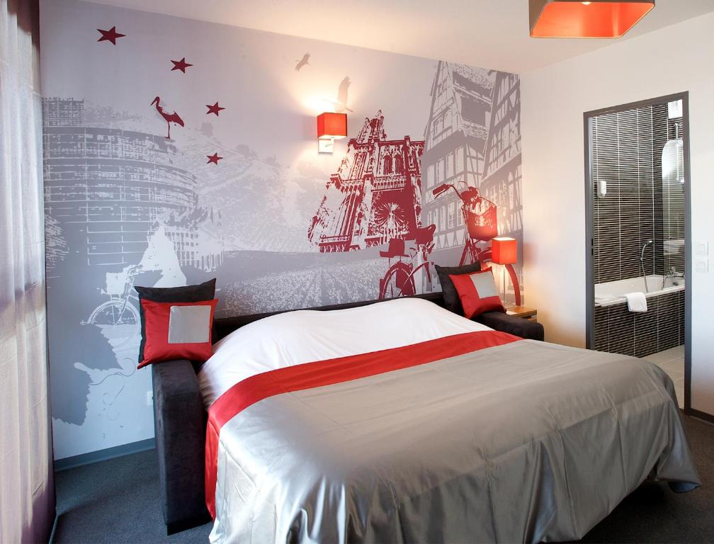 a bedroom with a large bed with a wall mural at Lagrange Apart’Hotel Strasbourg Wilson in Strasbourg