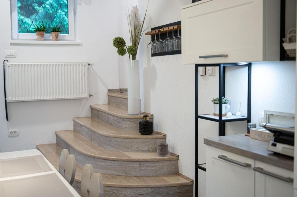a stairway in a kitchen with wooden stairs at River house HRIB in Preddvor