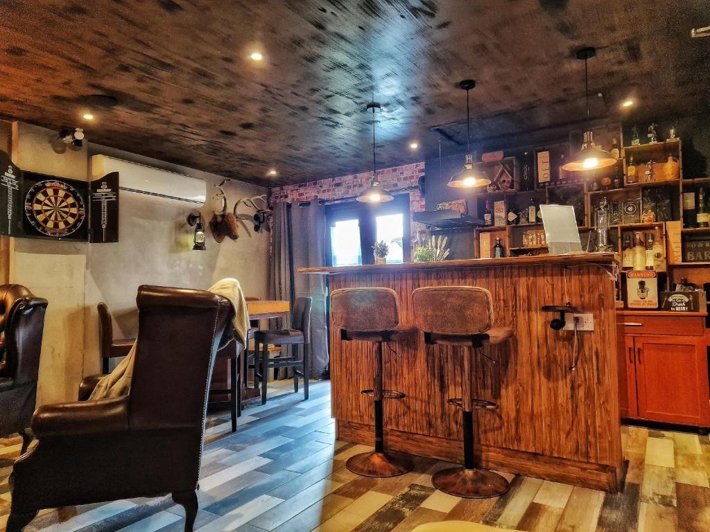 a bar with chairs and a table in a room at The Pub - Unique & Authentic Experience - Free Parking!, 5 minutes from Airbus in Bristol