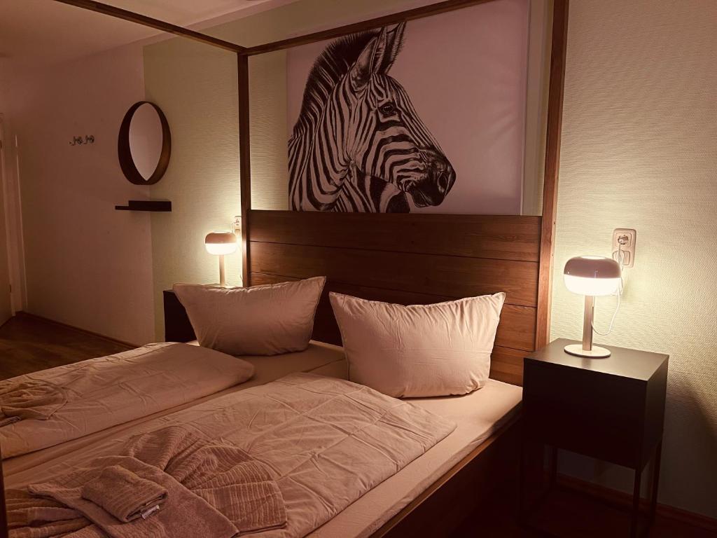 a bedroom with a bed with a picture of a zebra at MY HOME 4 person apart in Chemnitz