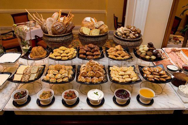 a table with many different types of food on it at Anita's Bed & Breakfast - Bedroom On Ground Floor With Backyard in Abbotsford