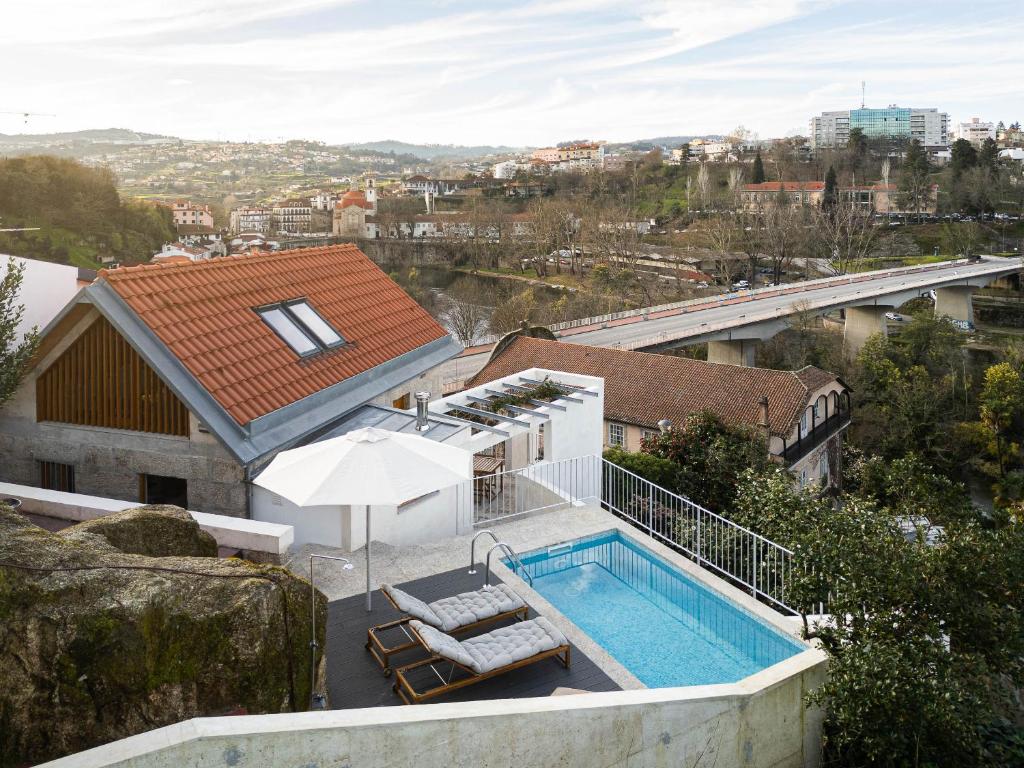 a house with a swimming pool next to a building at Casa da Corina in Amarante