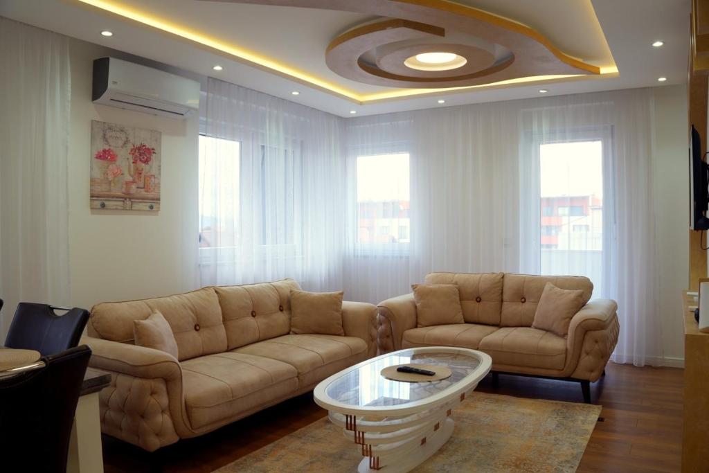 a living room with two couches and a coffee table at Triple A Apartments in Sarajevo