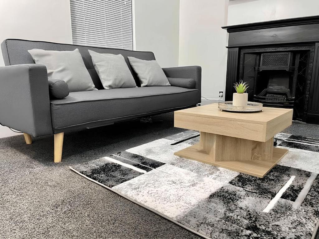 a living room with a couch and a coffee table at Home In Medway in Chatham