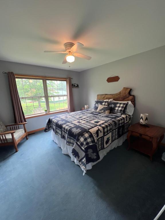 a bedroom with a bed and a ceiling fan at Relaxing Retreat in the Heart of the Finger Lakes!- Dog Friendly and Hot tub in Springwater