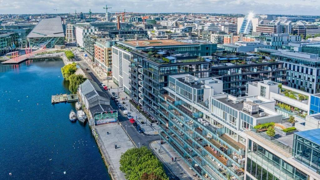 an aerial view of a city with a river and buildings at Elegant 2 Bedroom Apartment in Grand Canal in Dublin