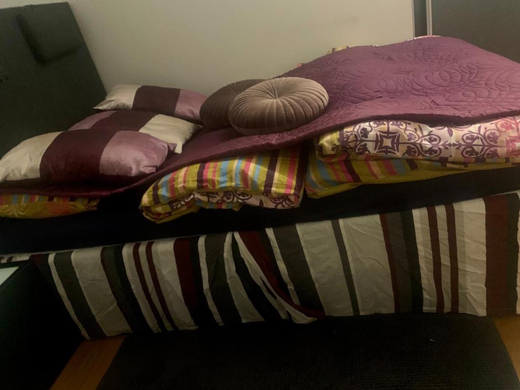 a pair of beds with colorful blankets and pillows at Centralt i Malmö in Malmö