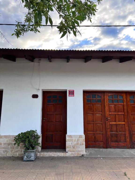 two wooden doors on the side of a white building at La casa de Ana in Alberti