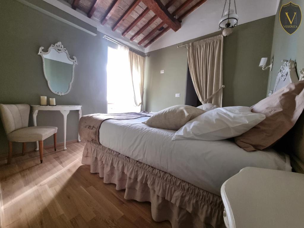 a bedroom with a large bed and a window at Vesionica Holiday House Perugia in Civitella Benazzone