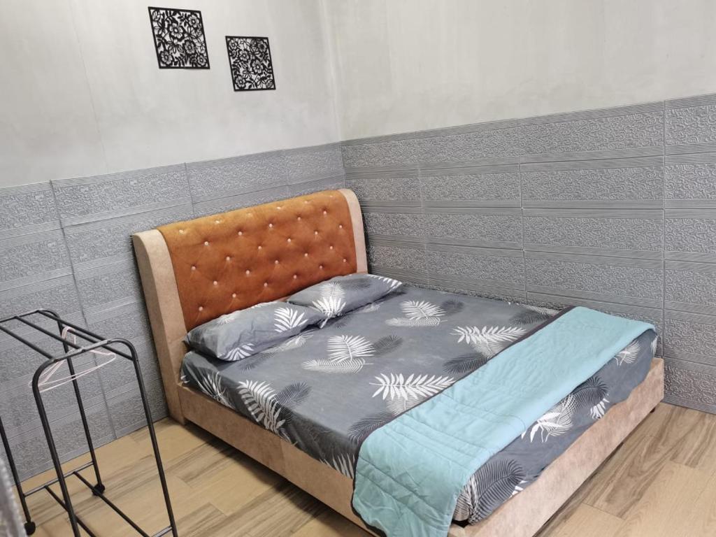 a small bed in a room with at VILLA HAJAH RUGAYAH BAKRI MUAR in Muar