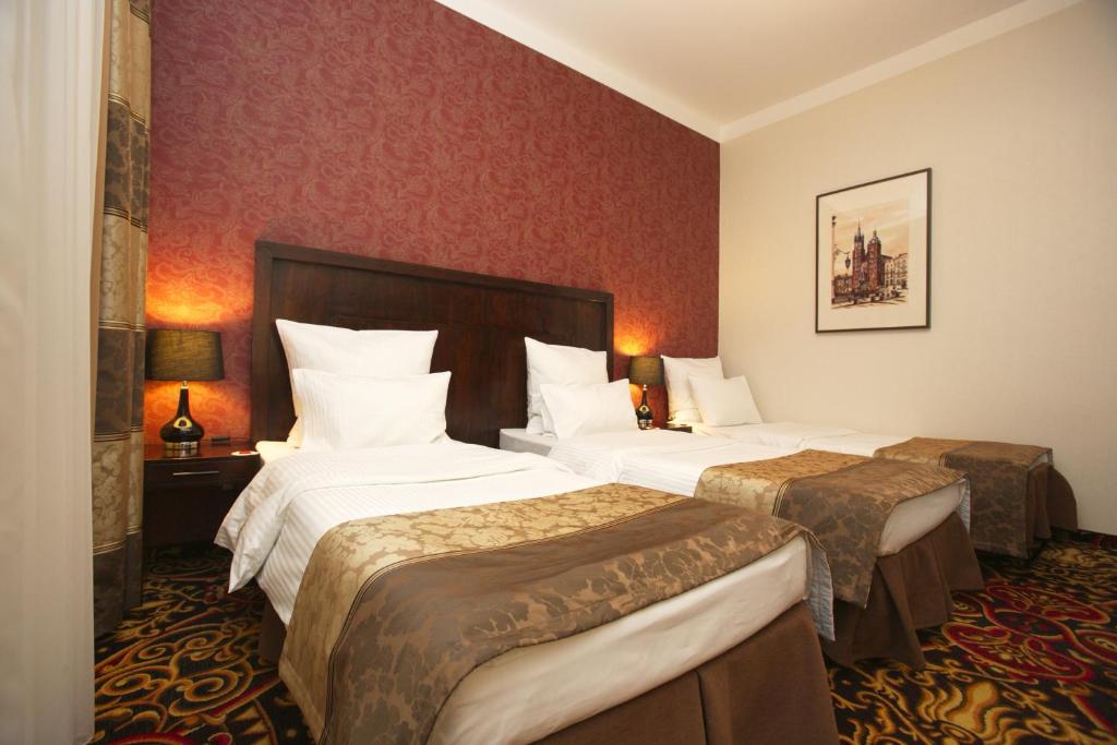 Säng eller sängar i ett rum på Hotel Columbus