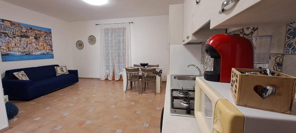 a kitchen and living room with a couch and a table at La Casa sulla Piazza in Sciacca