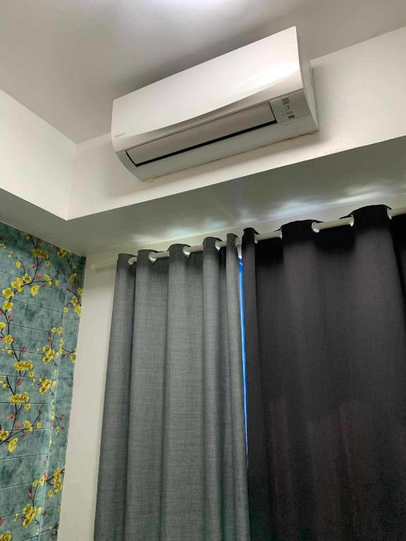 a room with a air conditioner above a curtain at Stay Cay Affordable Price by -Mang Domeng in Manila