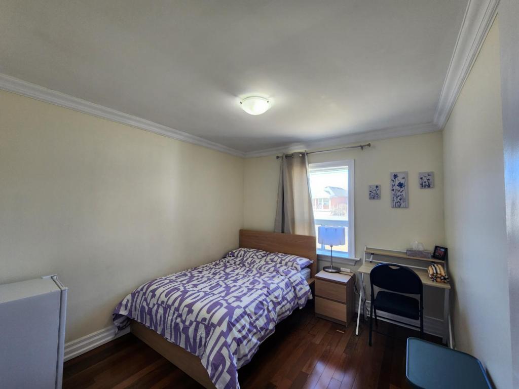 a bedroom with a bed and a desk and a window at Toronto Uptown 2 - Bus Accessible to Downtown in Toronto