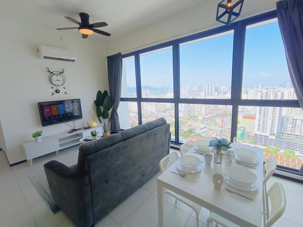 a living room with a couch and a table at Infinity Pool, Georgetown, Up to 11 Pax, 3 Bedrooms, 2 Bathrooms, 2 Car Parks by Star Home in Jelutong