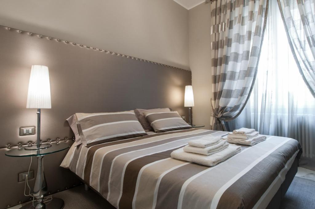 a hotel room with a bed and a lamp at Brera Prestige B&B in Milan