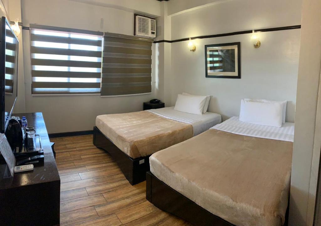 Postel nebo postele na pokoji v ubytování Venus Parkview Hotel