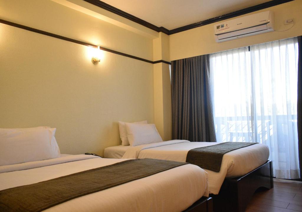 Postel nebo postele na pokoji v ubytování Venus Parkview Hotel