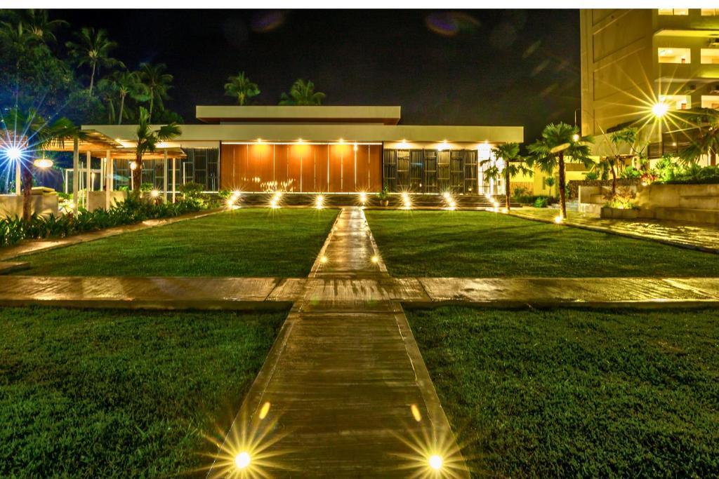 a walkway in front of a building at night at Bluebells 1 BR Superior Room ZN33 in Senggigi 