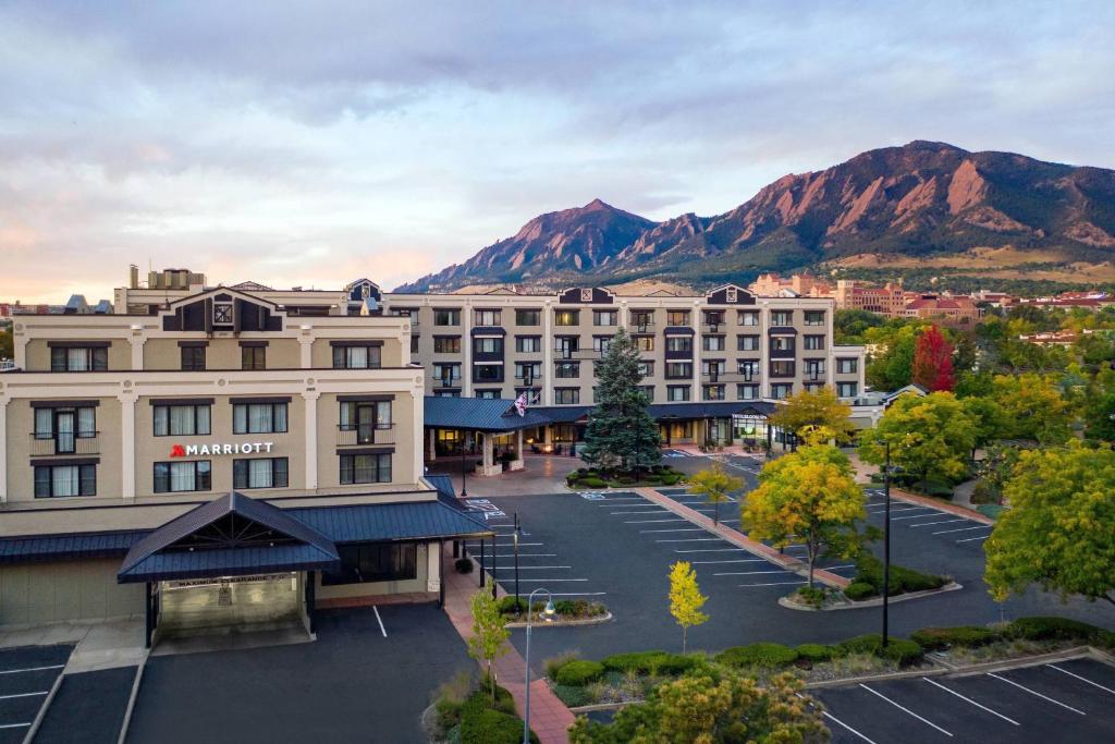 an aerial view of a hotel with mountains in the background at Boulder Marriott in Boulder