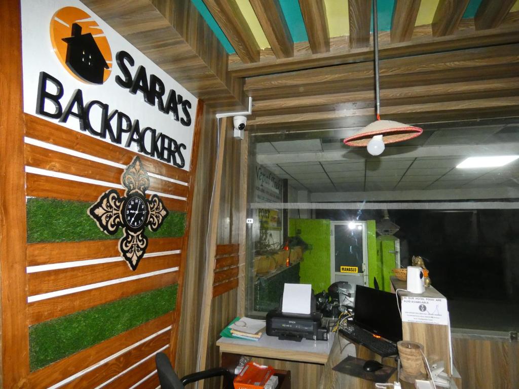 an office with a santas barbecue sign on a wall at Sara's Backpackers Hotel in Kathmandu