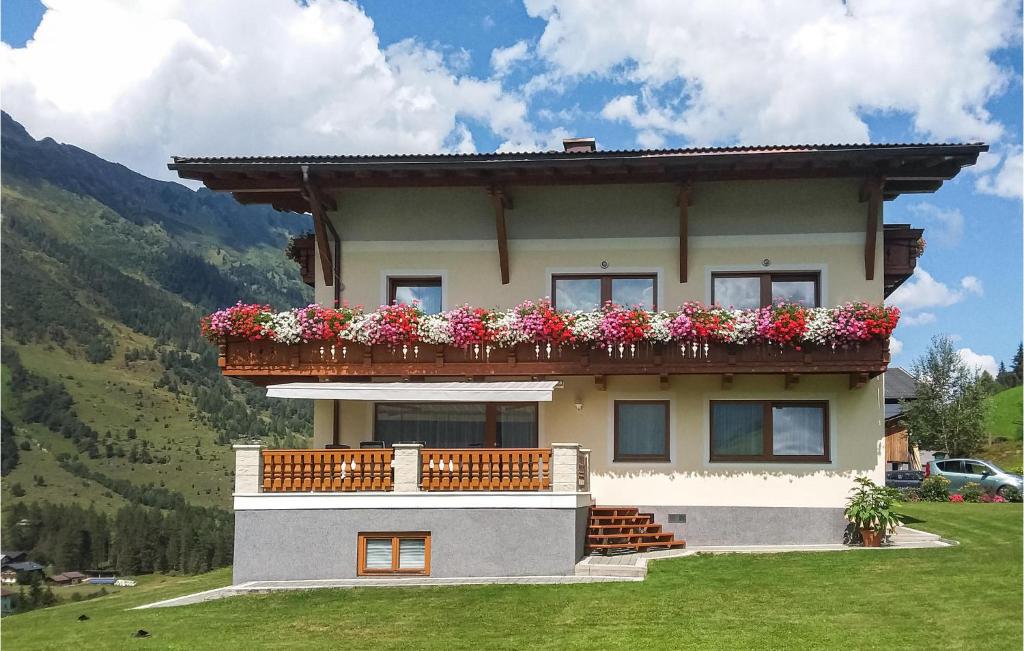 a house with a balcony with flowers on it at Beautiful Apartment In Rauris With 2 Bedrooms And Internet in Rauris