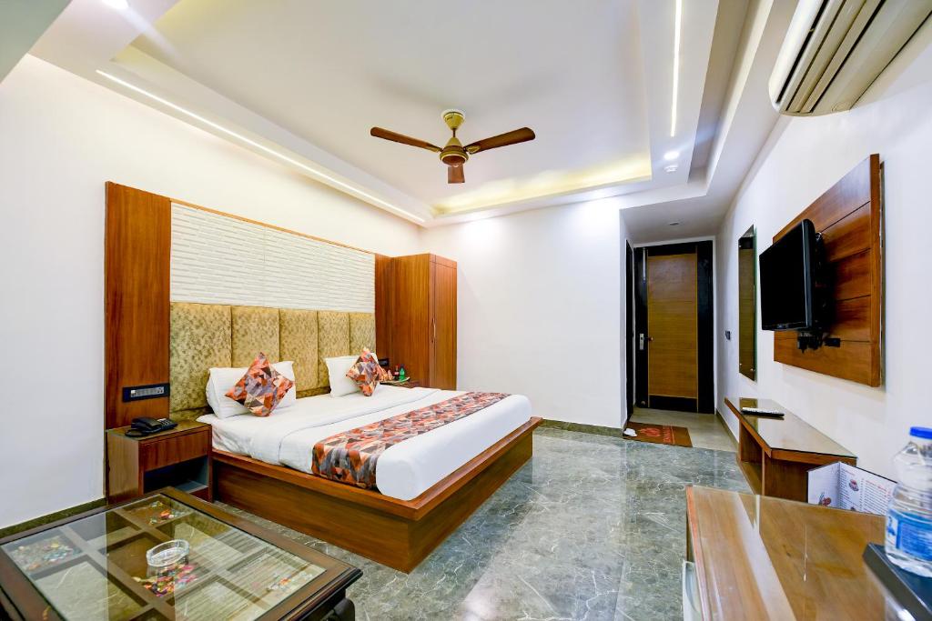 a bedroom with a bed and a flat screen tv at Hotel Sohana Palace Near New Delhi Railway Satation in New Delhi