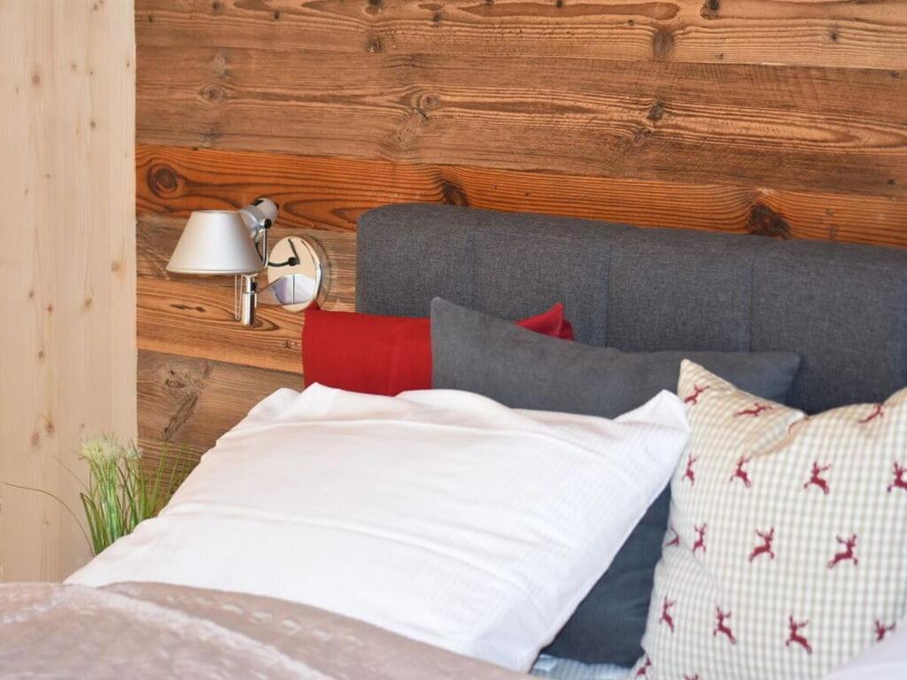 a bedroom with a bed with red and white pillows at Holiday apartment Alpenblick in Sankt Lorenzen ob Murau